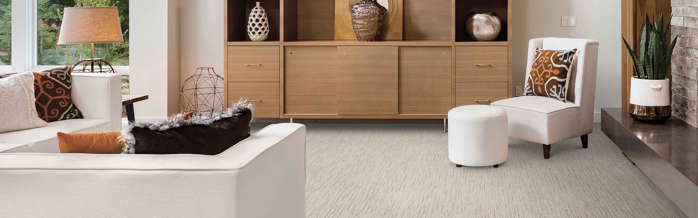 beige textured carpet in modern living room with built-in cabinet, white furniture and fireplace