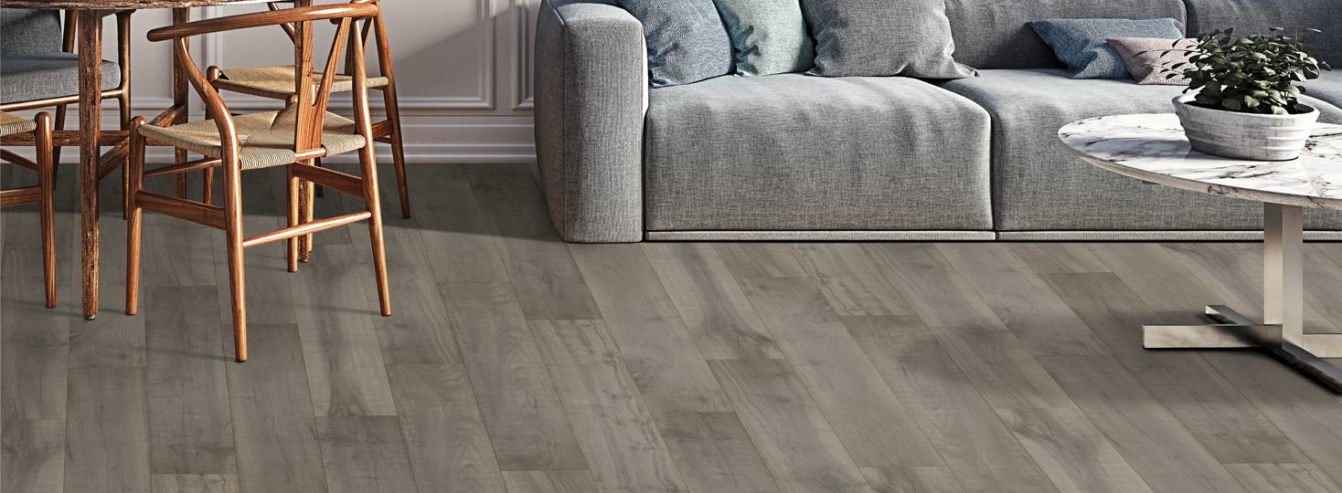 gray laminate flooring in living room with couch and chairs